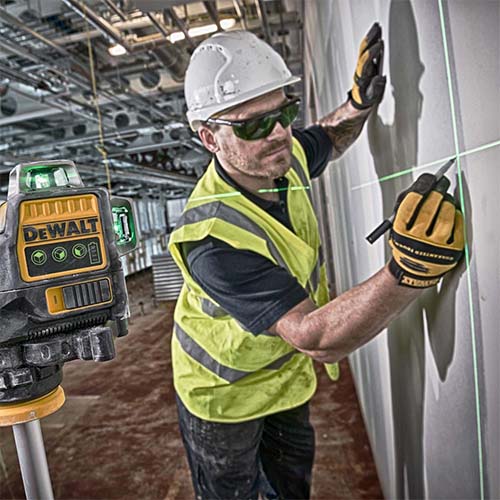 Dewalt 360 Green laser level being used by a construction worker making a pencil mark on a wall arguably the best dewalt laser on the market