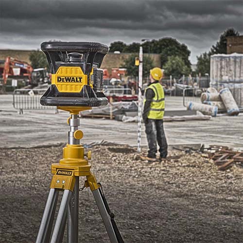 Image of a construction worker looking at a laser distance measurer, The laser being used is a DCE074D1R Dewalt rotary laser
