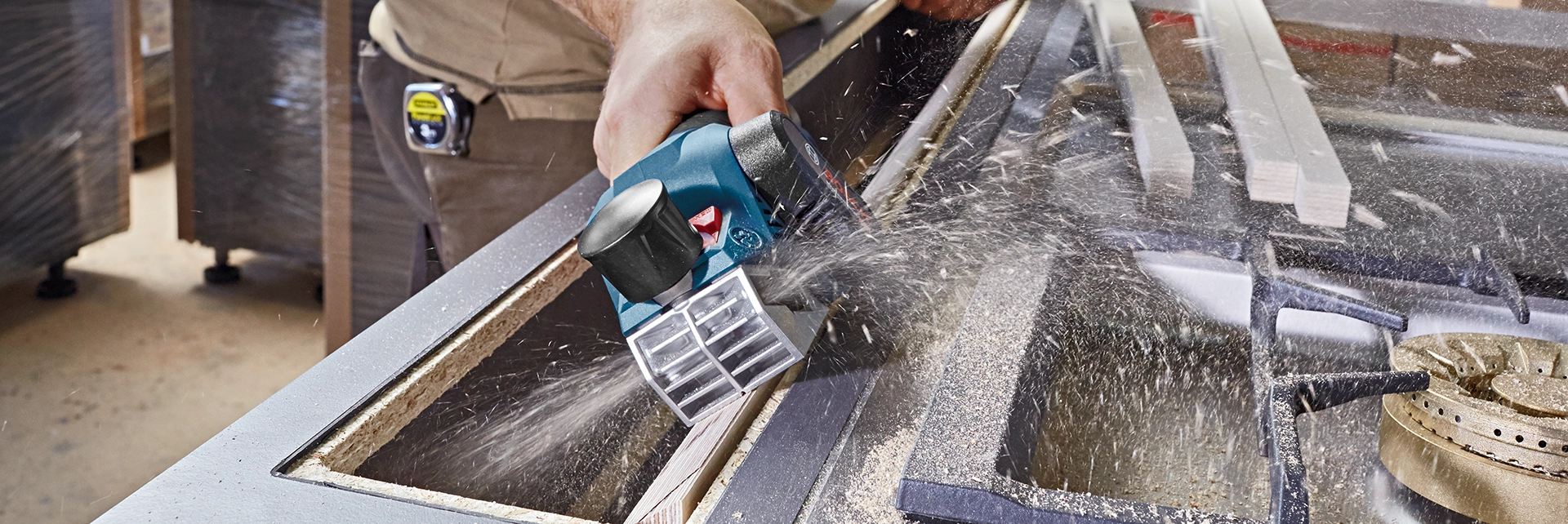 Lifestyle picture of a hand using the Bosch GHO 12V-20 12V Brushless 56mm Planer.